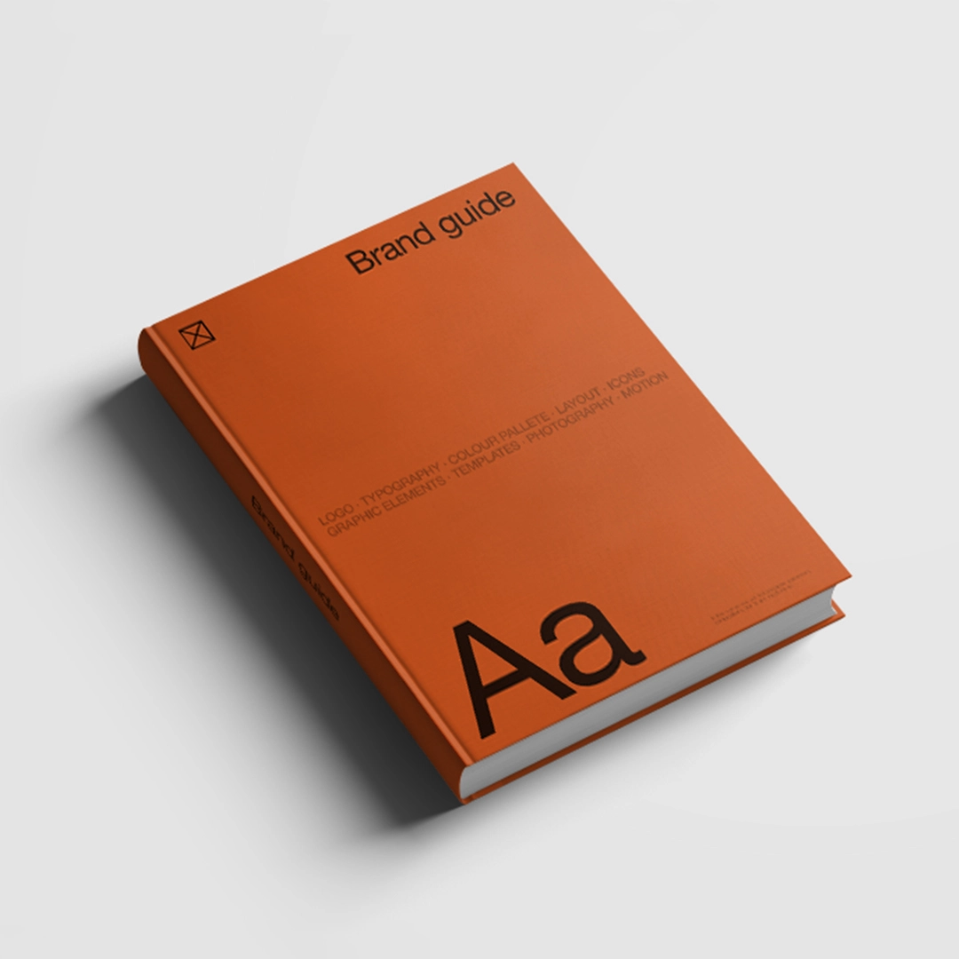 Orange book titled 'Brand guide', containing guidelines for developing visual identity, including logo, typography, and color palette, helping to build a cohesive brand identity.