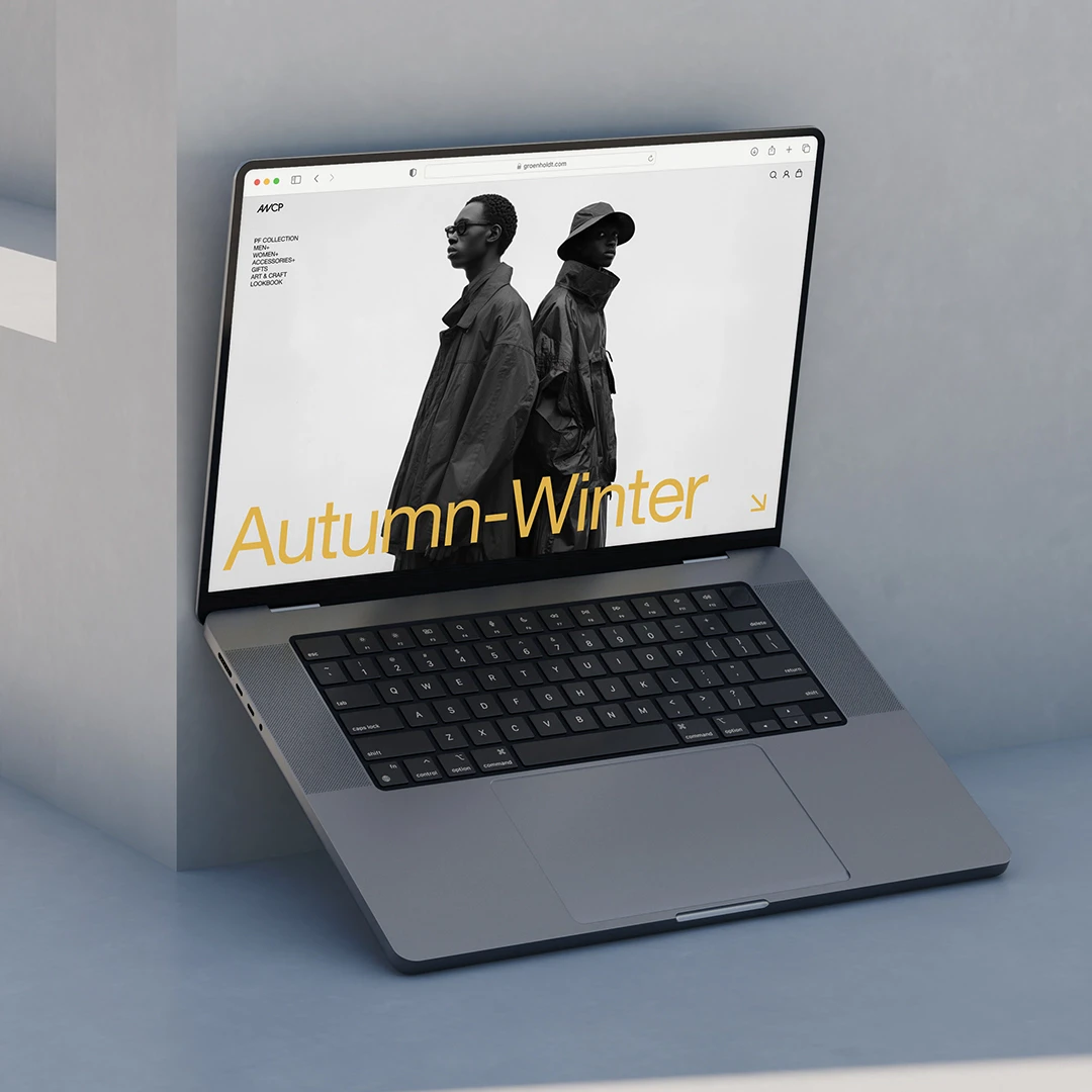 Laptop displaying a minimalist website for a fashion brand, designed in black and white with yellow text. The web design focuses on intuitive user experience using Figma, and the site can be developed on platforms like Shopify and WordPress.